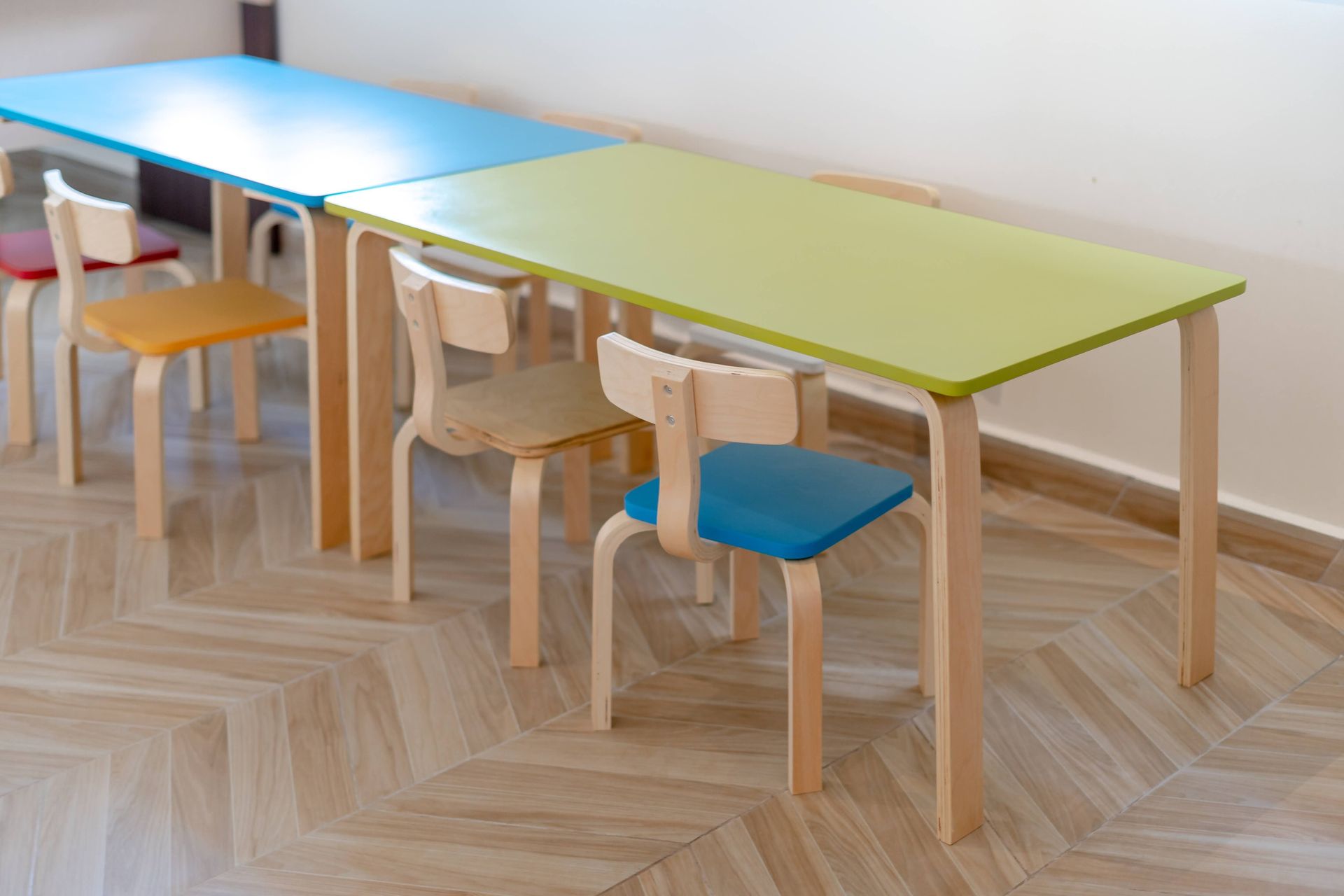 Vibrant child-sized chairs and tables in an educational setting.